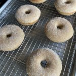 cinnamon donuts on a cooling rack